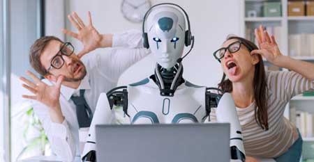 Two humans make faces at a robot typing on a keyboard, doing their job