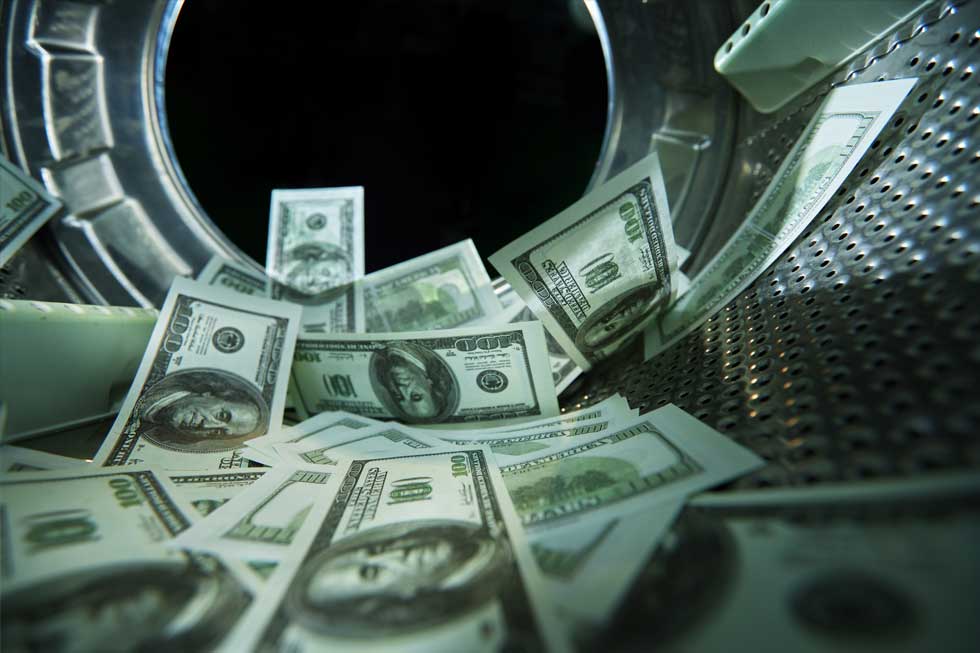 A bunch of US bills are being washed in a large washing machine